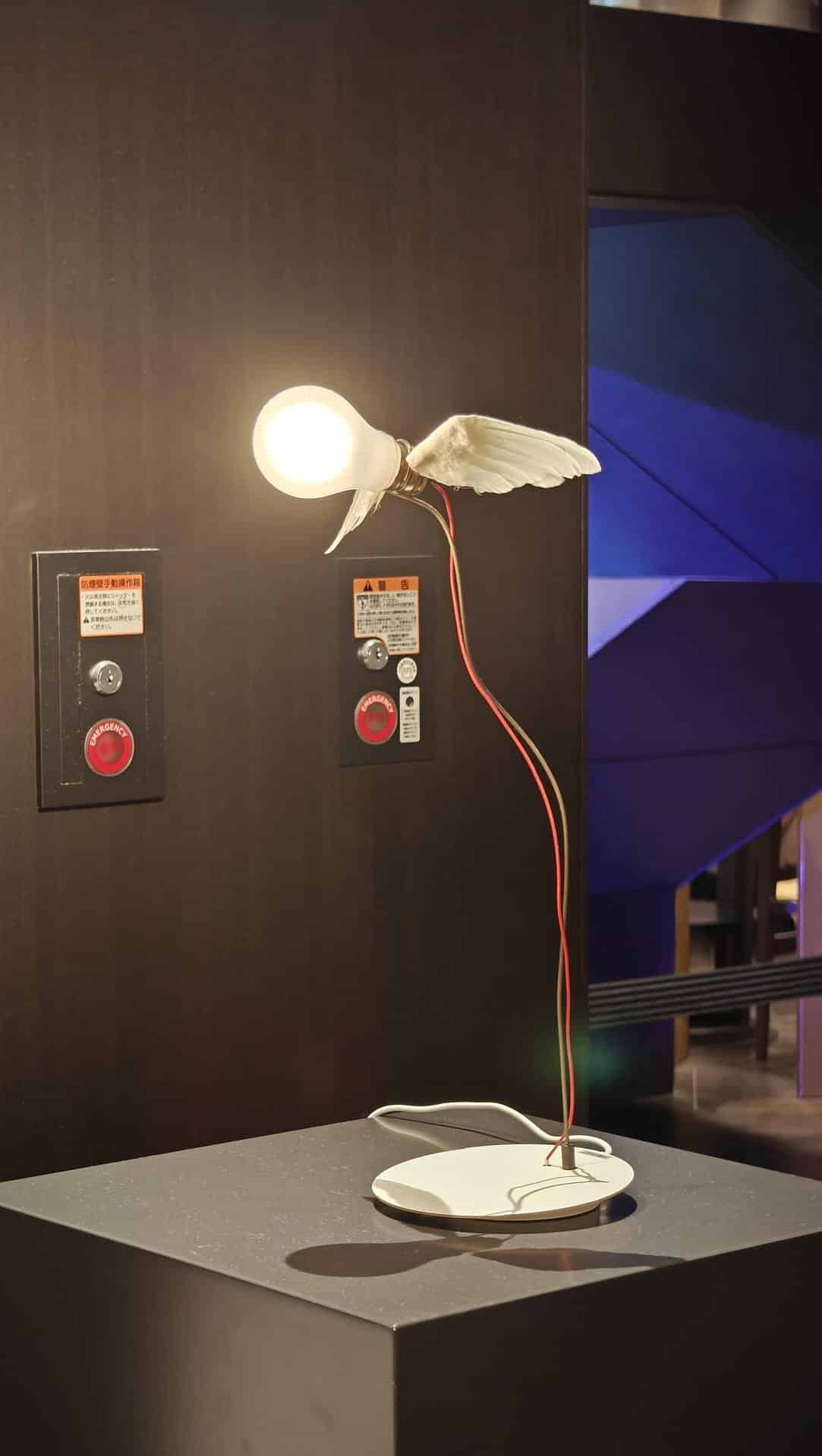 Winged bulb lamp on display