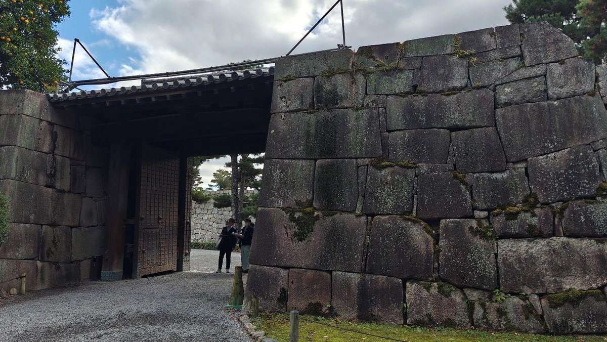 Ancient stone gate under cloudy sky