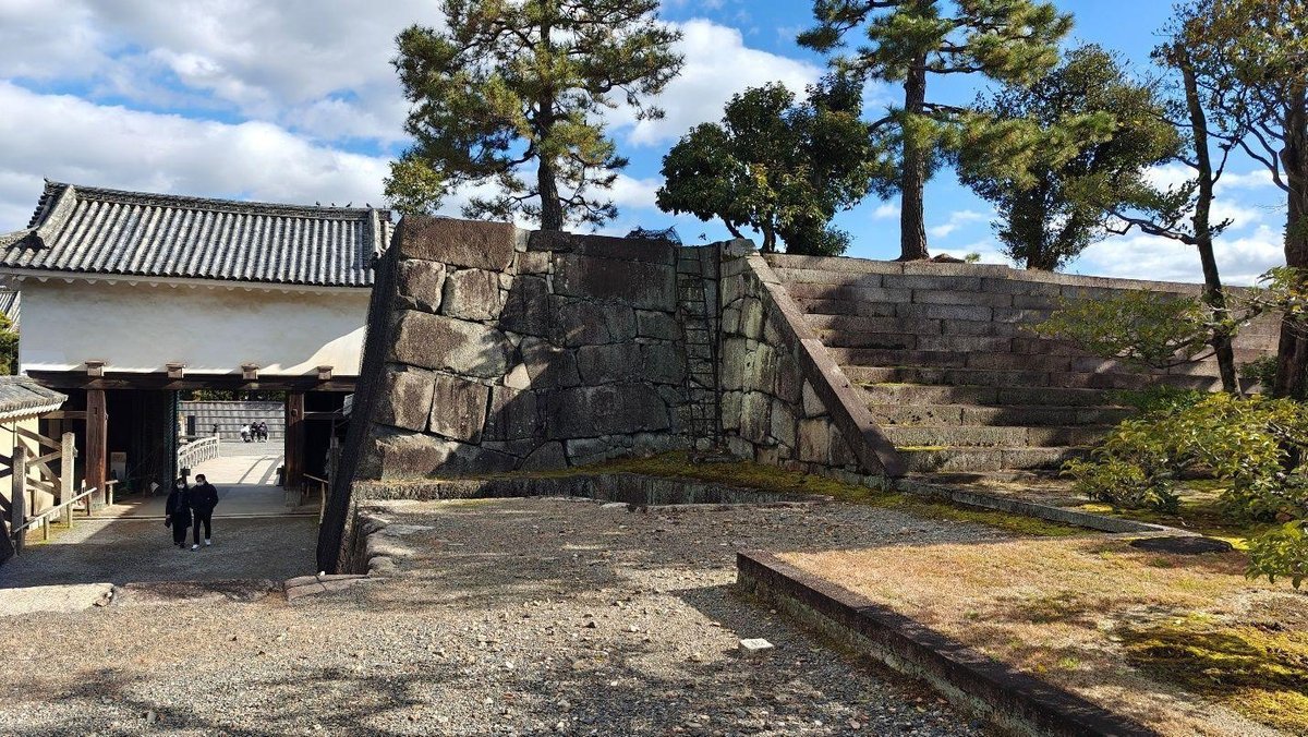 Historic stone gate with trees and stairs