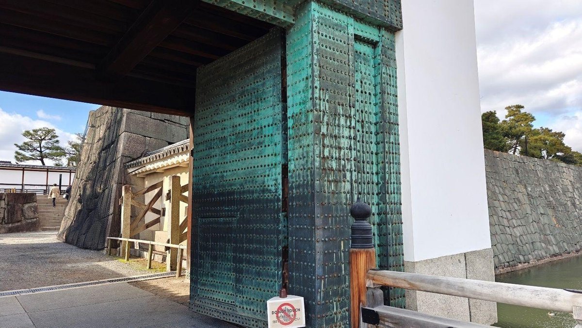 Historical metal gate with stone walls