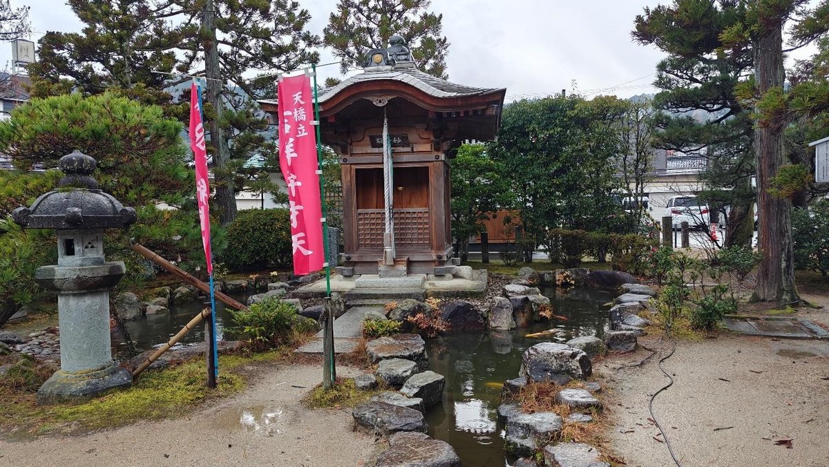 Japanese garden with stone lantern and small shrine