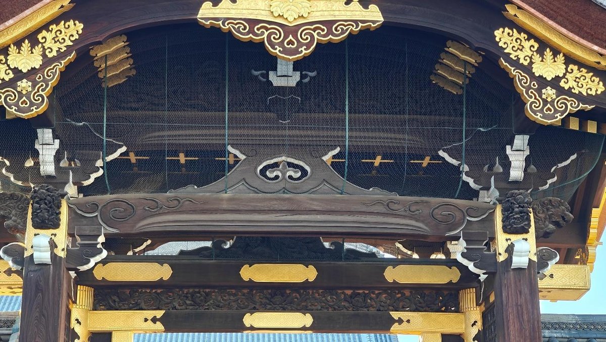 Ornate wooden temple roof with intricate gold detailing