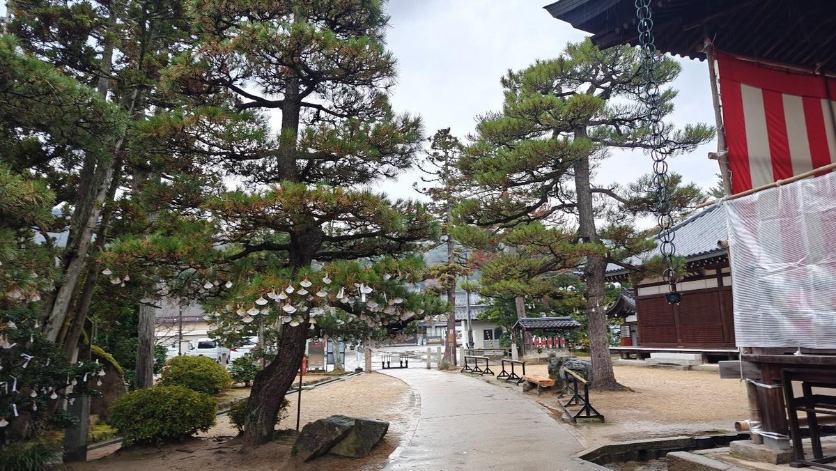 Peaceful temple garden with trees and red striped curtain