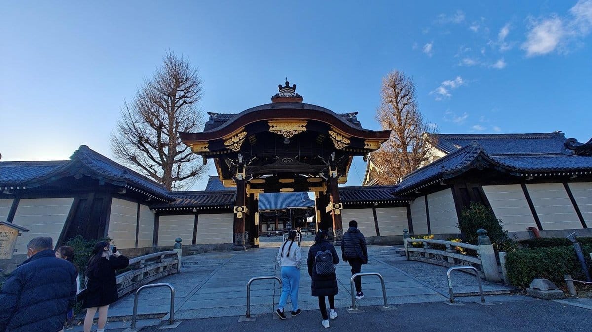People at traditional Japanese temple entrance