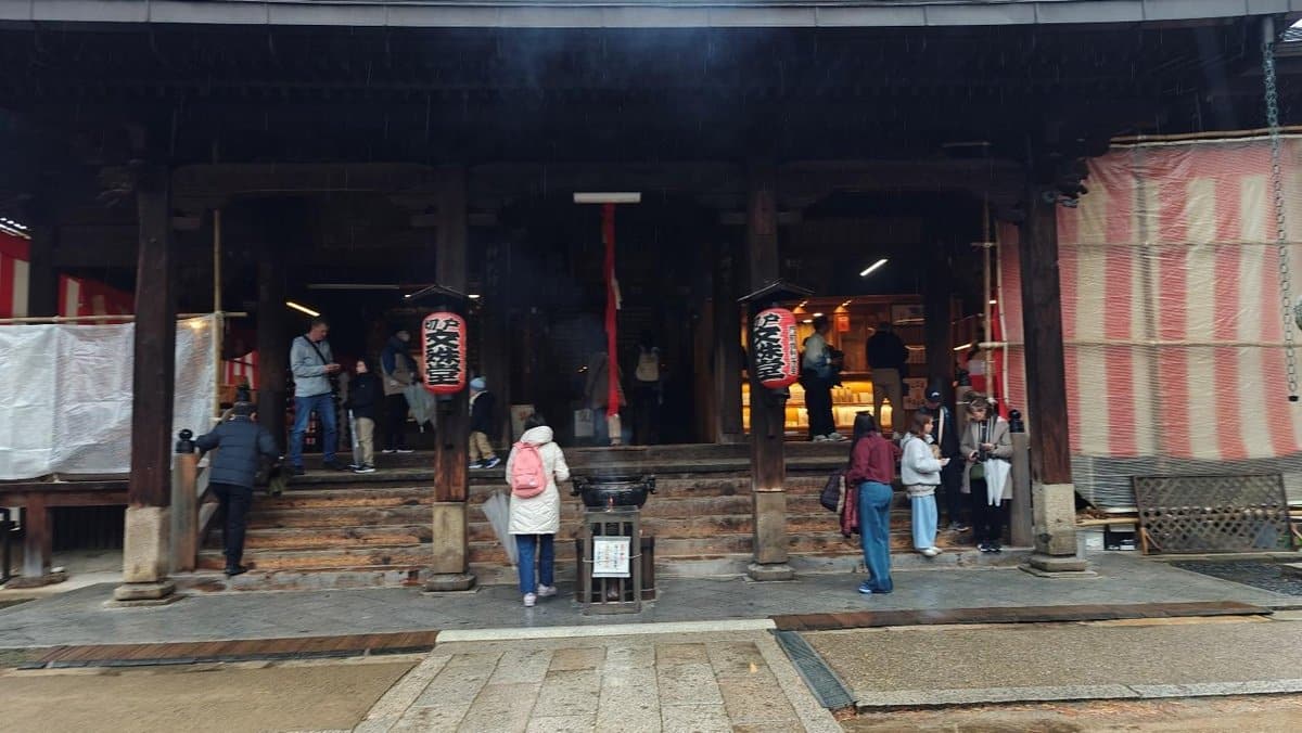 People gather at traditional temple with red lanterns