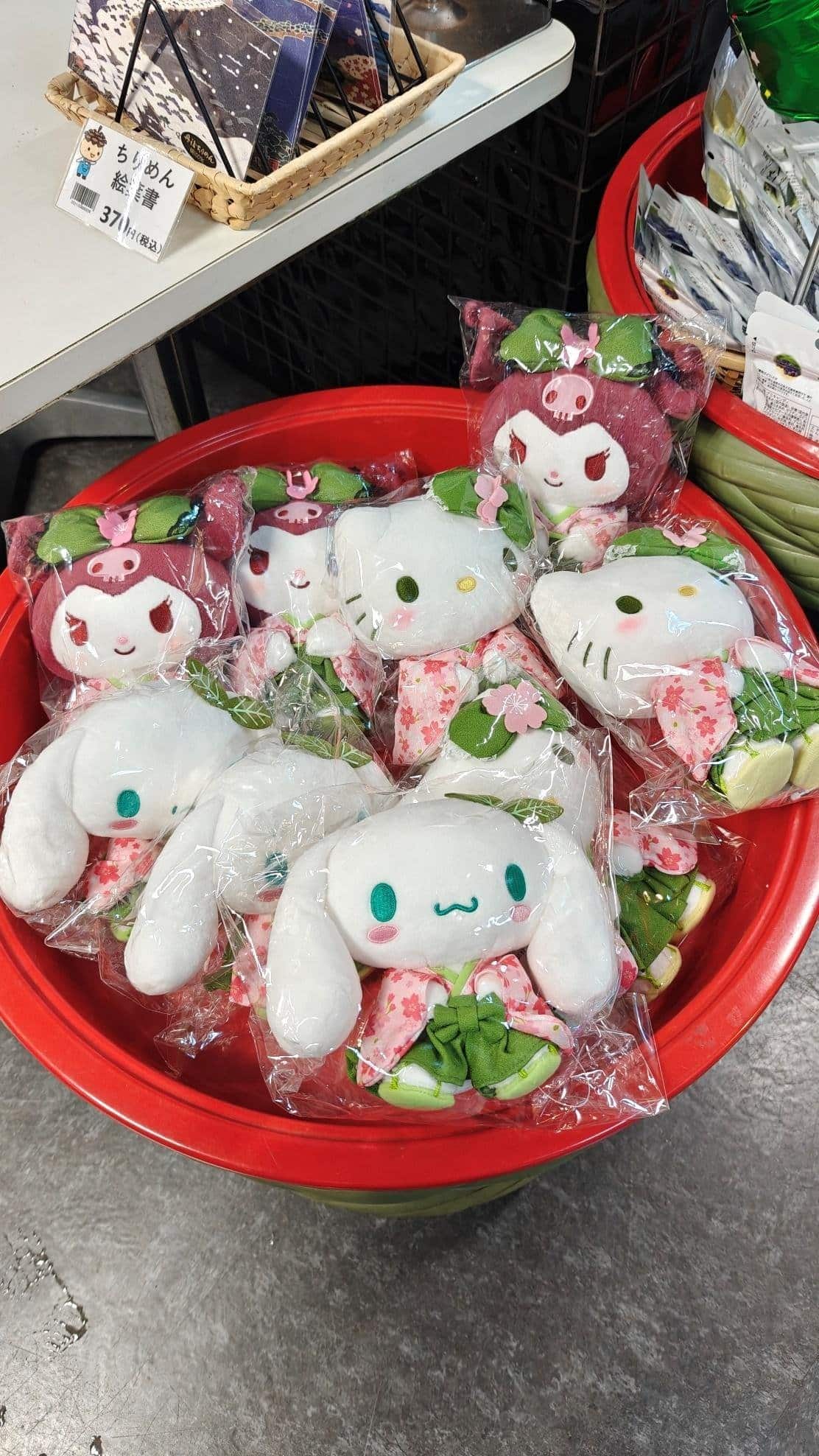 Plush toys in red bin with floral designs