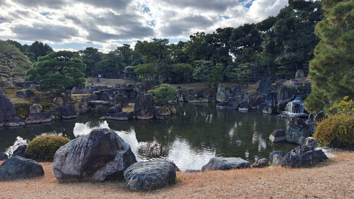 Serene garden pond with rocks and trees