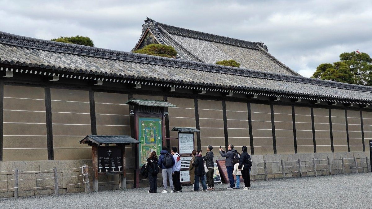 Tourists examining historic wall map
