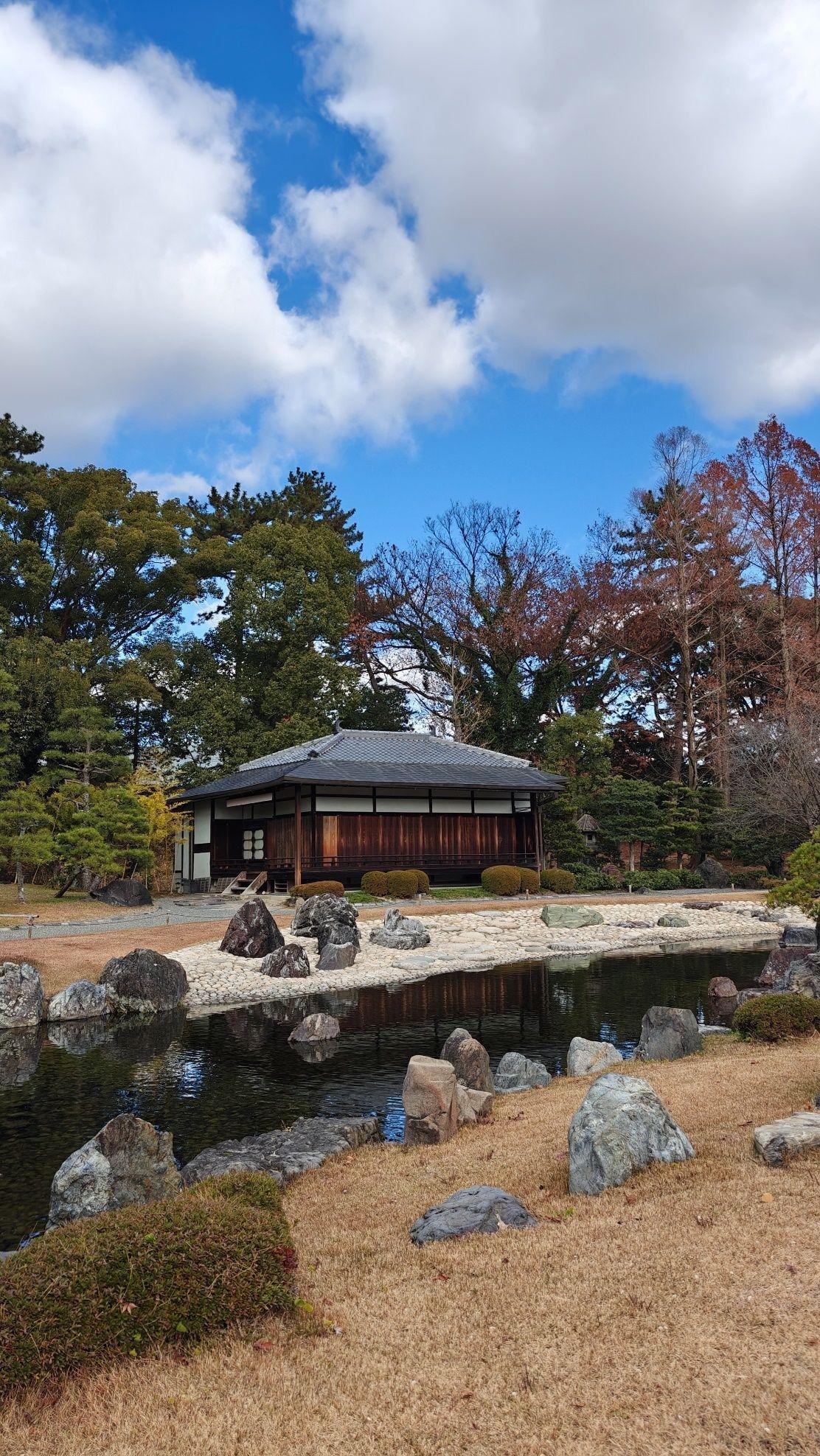 Traditional house by a serene garden pond