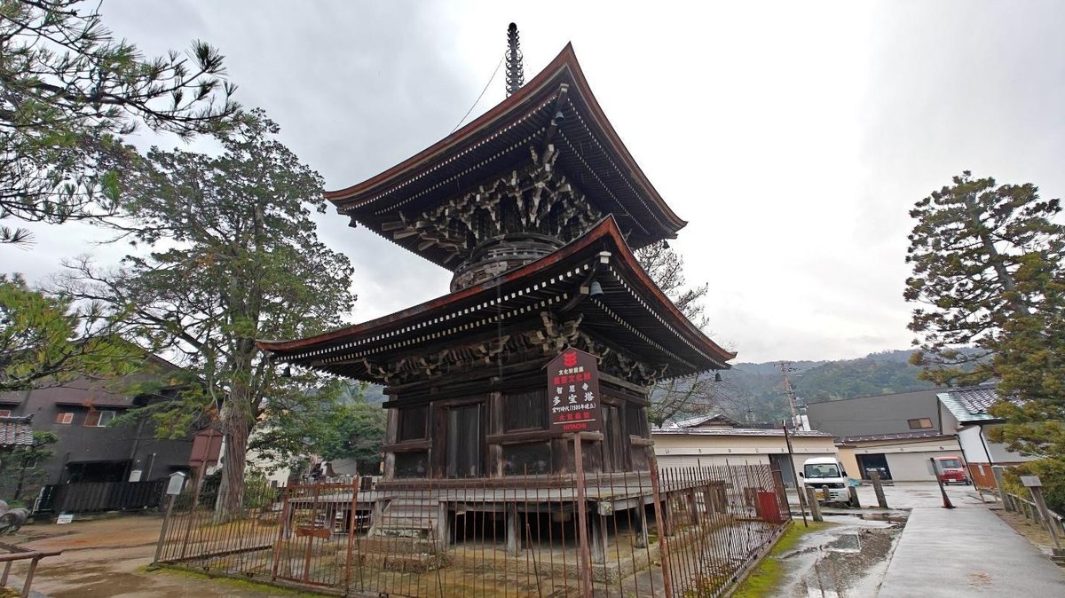 Traditional Japanese pagoda with trees and cloudy sky