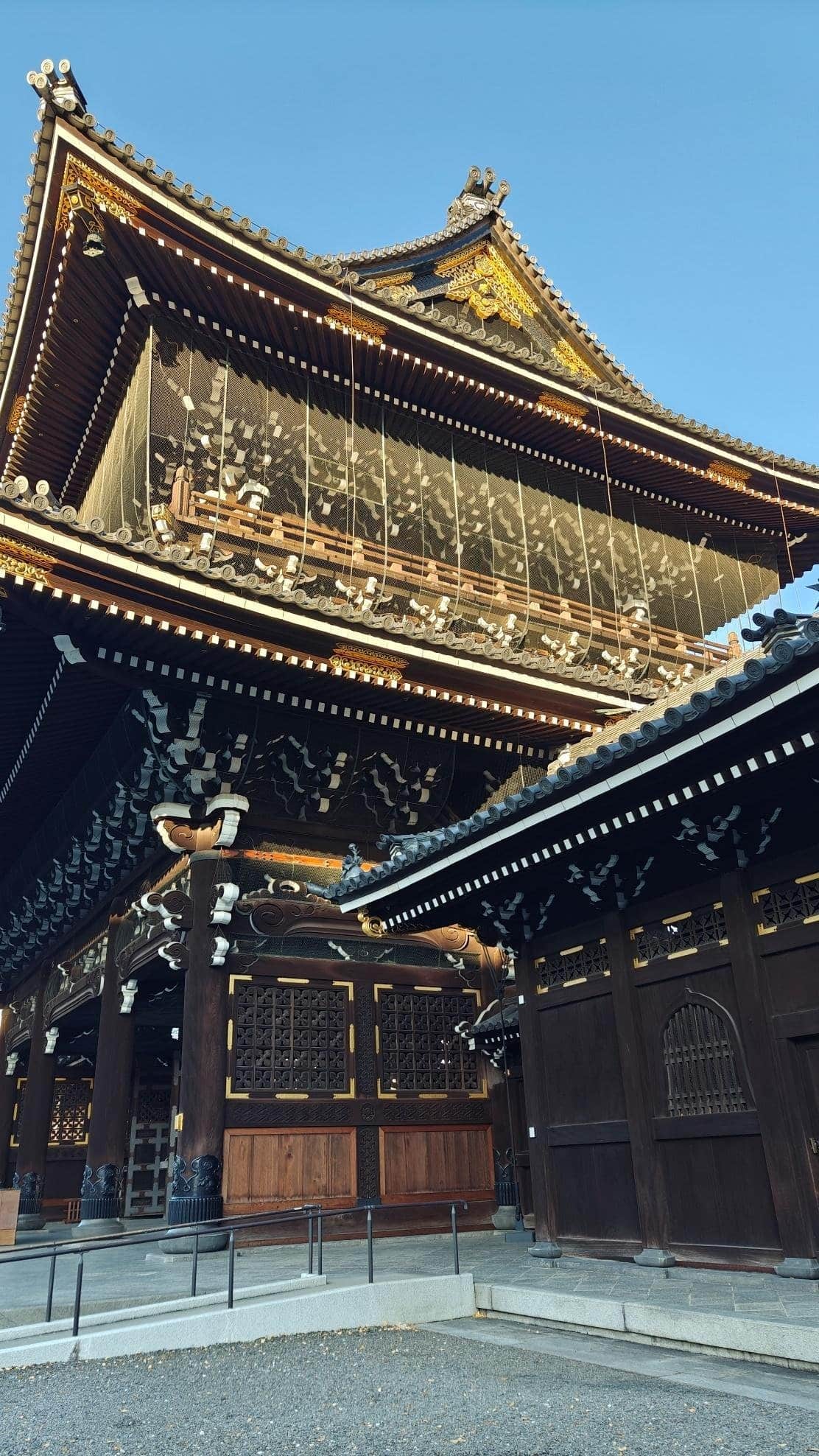 Traditional Japanese temple gate under clear blue sky