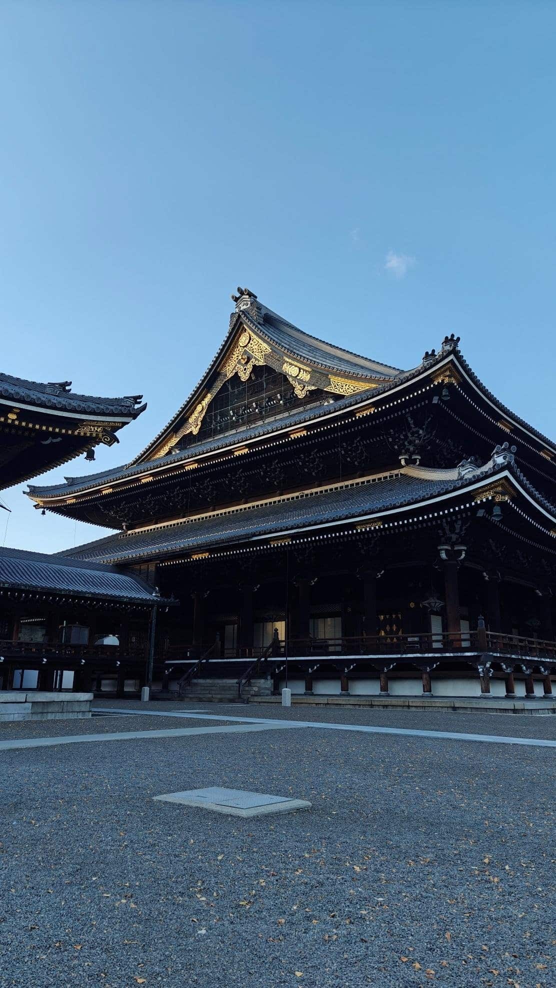 Traditional Japanese temple with ornate roof under clear sky