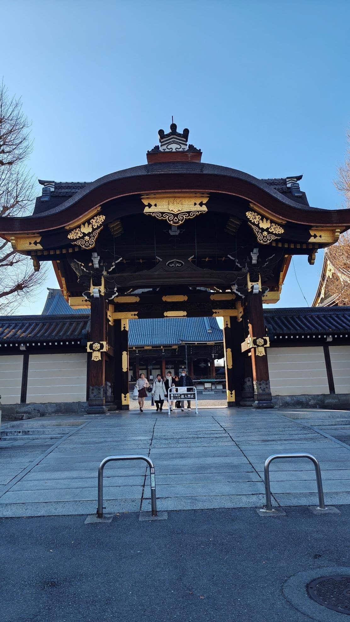 Traditional ornate temple gate under clear blue sky