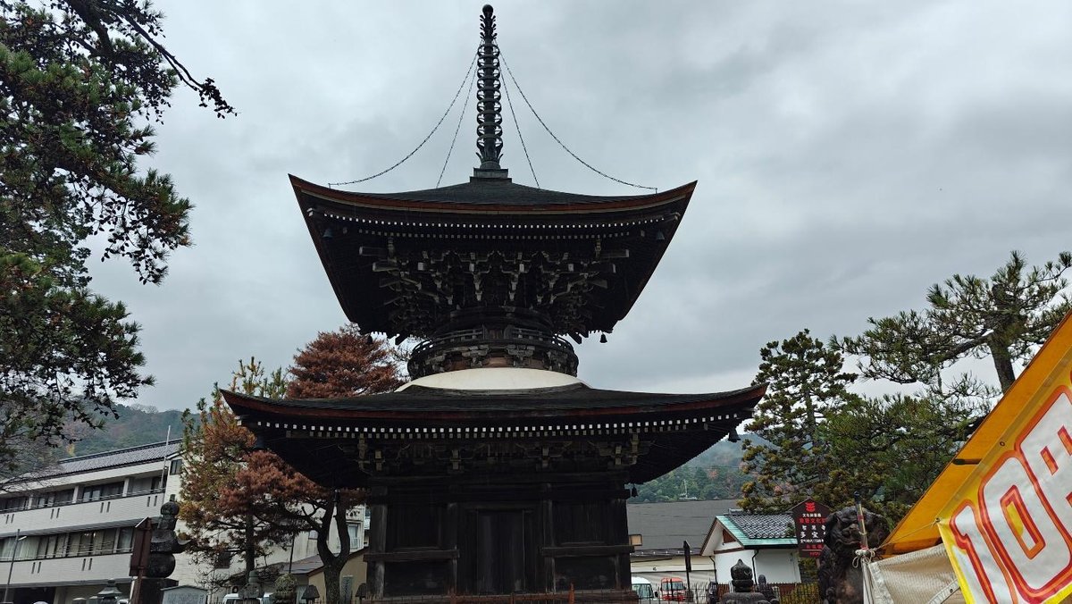 Traditional pagoda amidst trees under cloudy sky