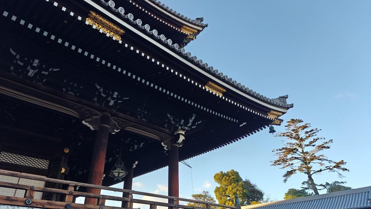 Traditional temple roof under clear blue sky