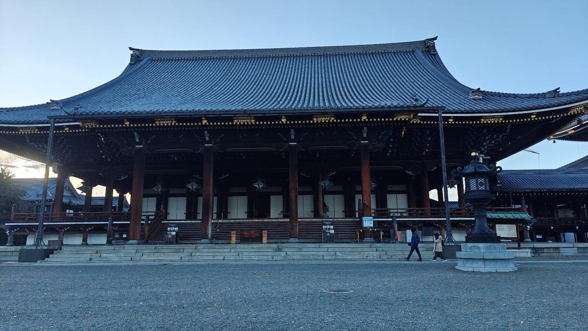 Traditional temple with intricate wooden architecture under blue sky