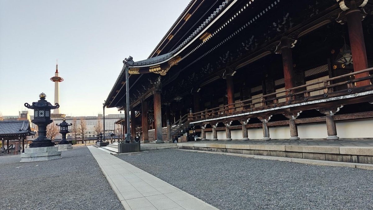 Traditional temple with lanterns and distant tower