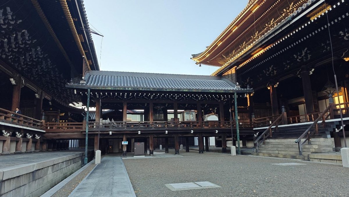 Traditional wooden architecture with ornate roof in sunlight