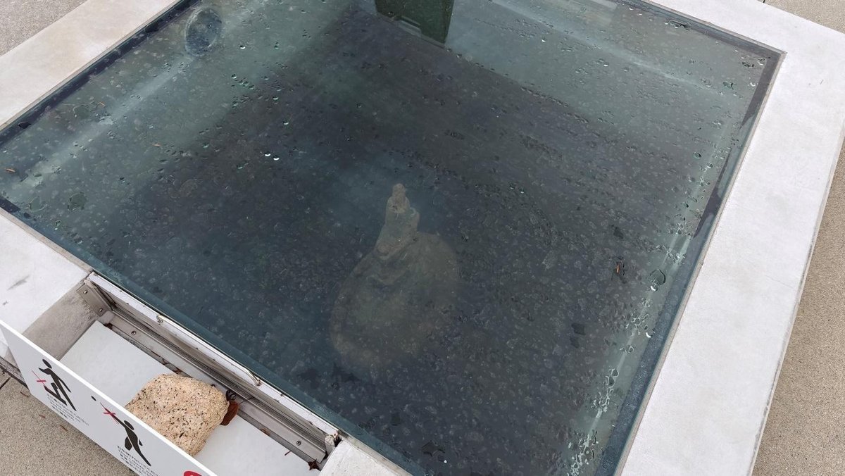 Transparent floor with a statue visible underwater