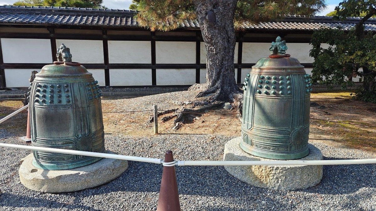 Two bronze temple bells, serene setting