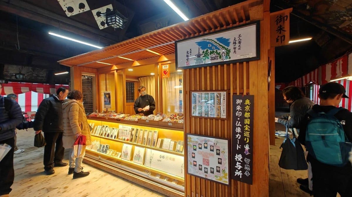 Visitors at a wooden booth selling souvenirs and crafts