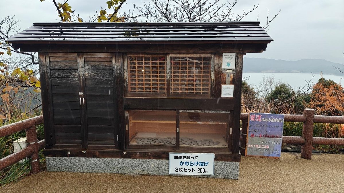 Wooden structure by railing and scenic waterfront view