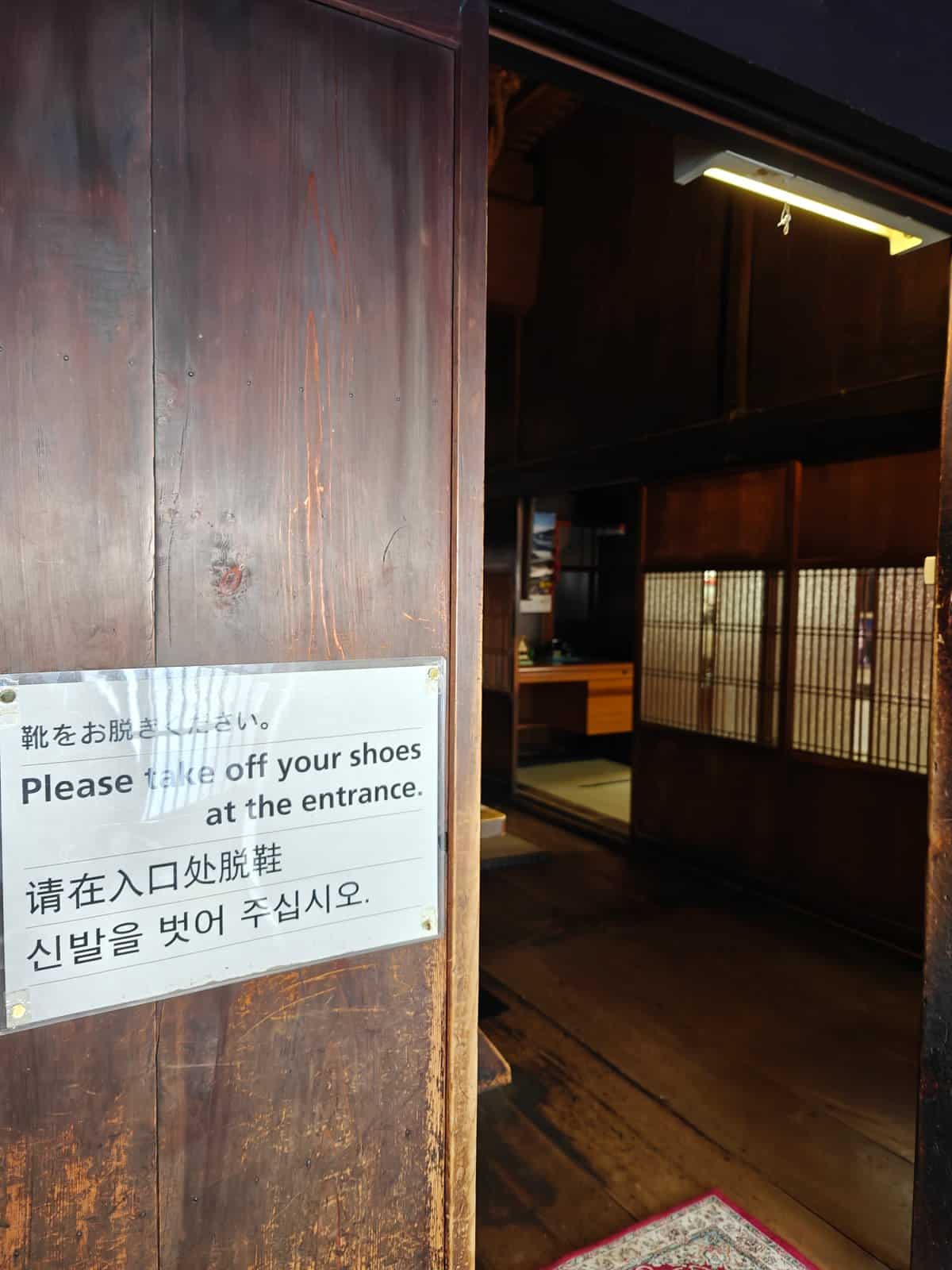 A laminated multilingual sign fixed to a dark