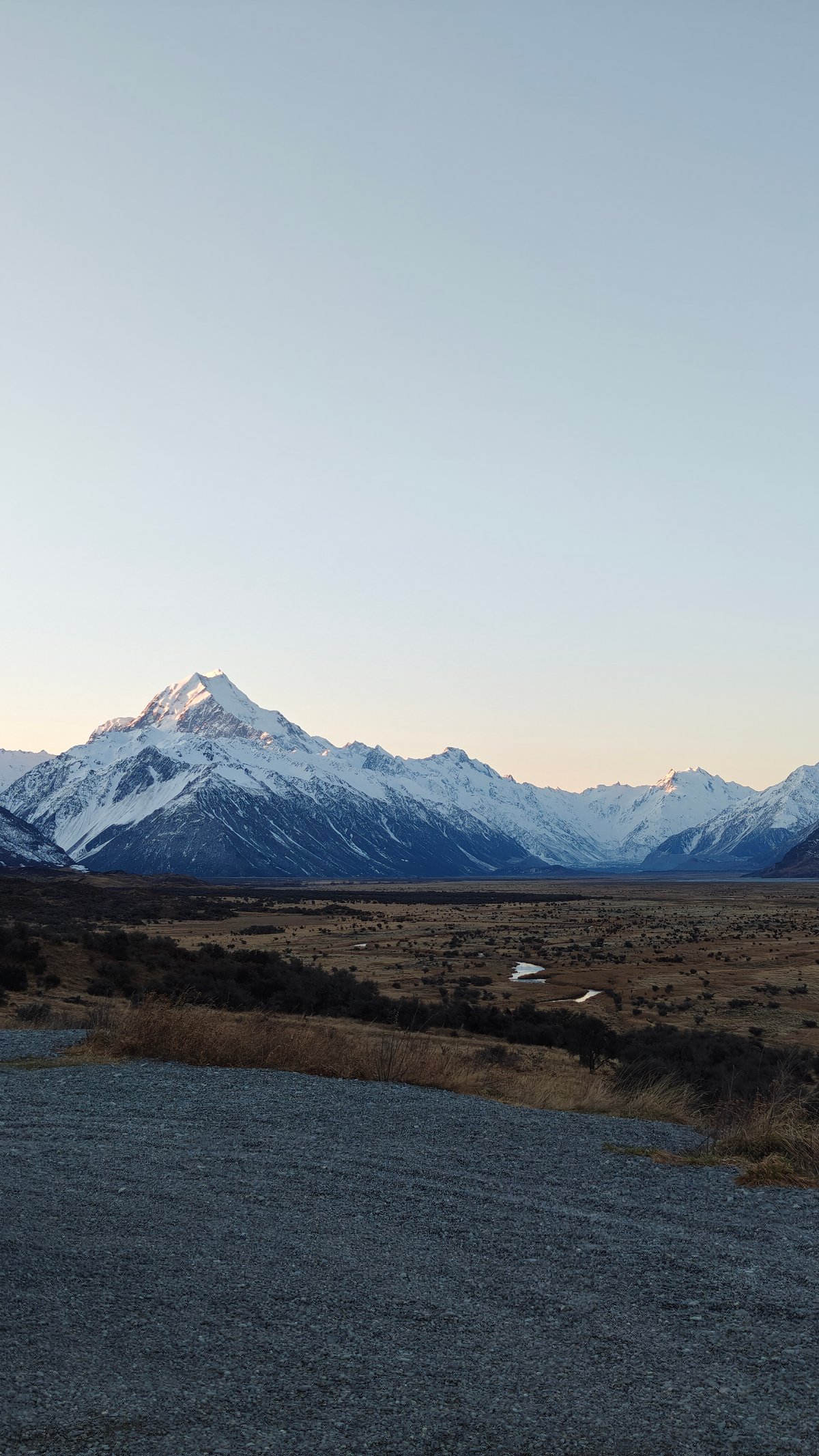 A sharp snow-capped peak rising above a shadowed