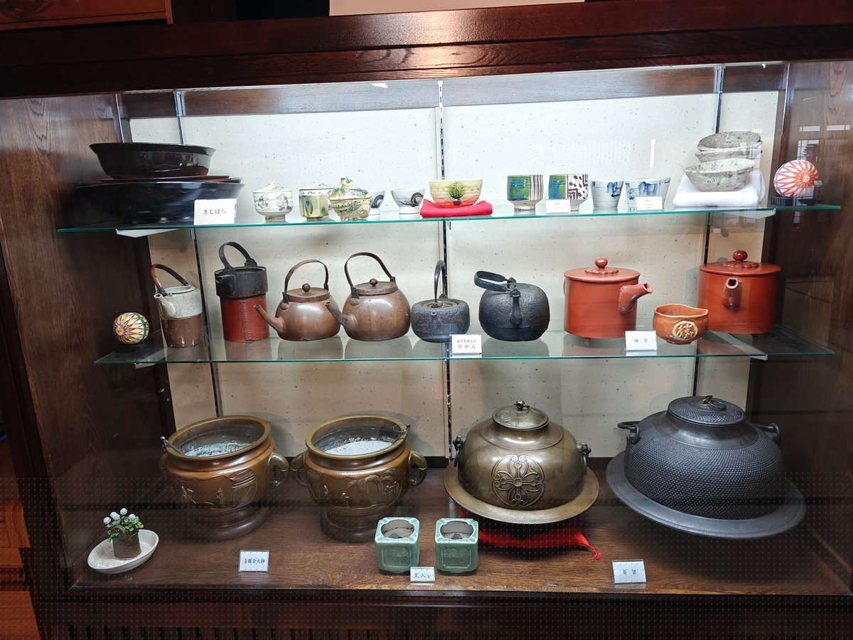 A tall three-shelf glass display cabinet of old