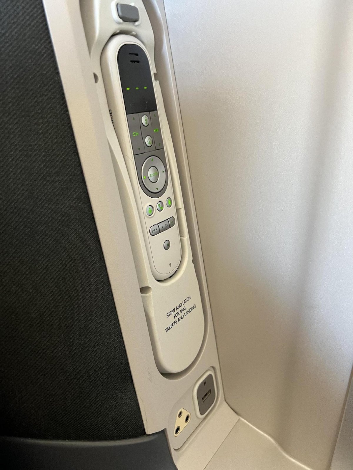 Airplane armrest with remote control