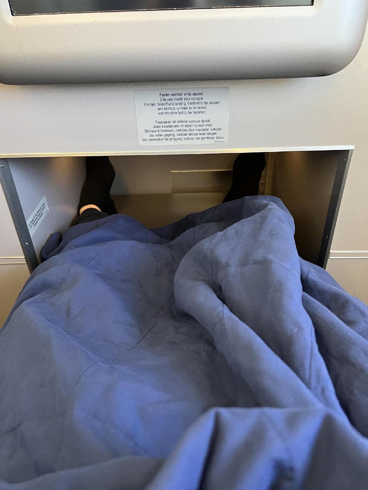 Airplane seat with blanket and footrest