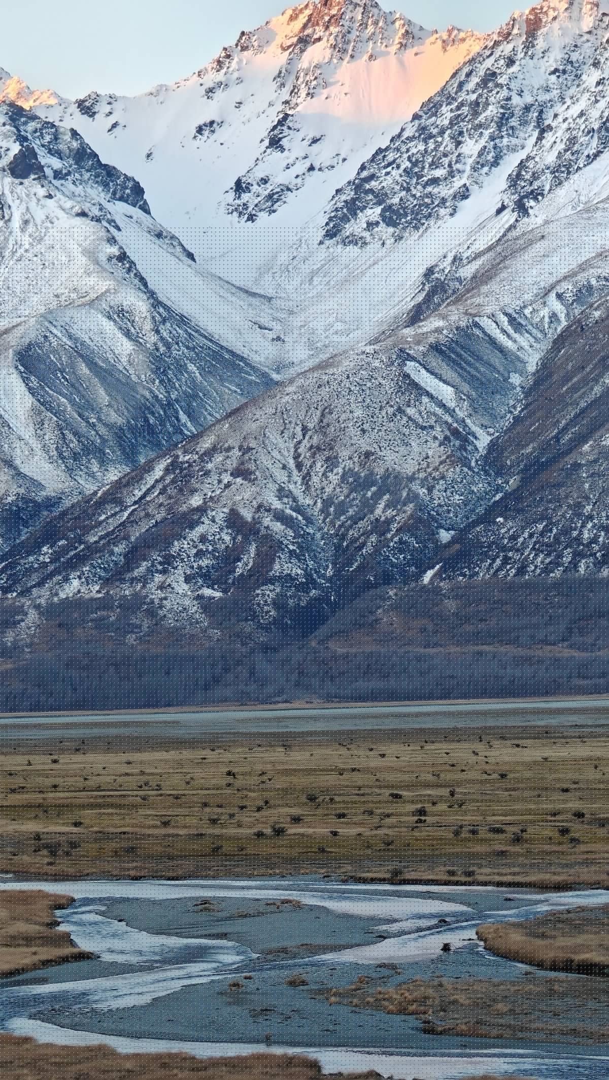 Alpenglow peaks above braided river