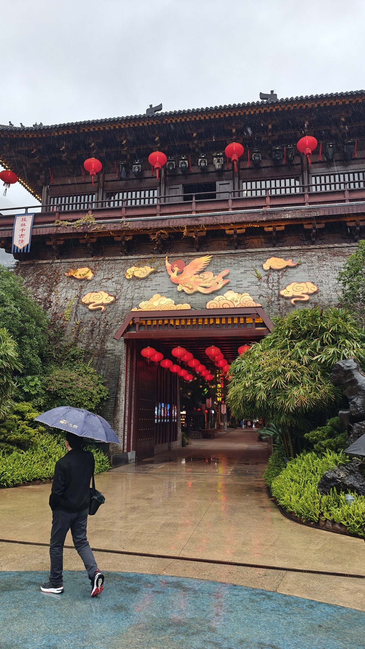 Ancient-style gate building with golden phoenix decoration, red