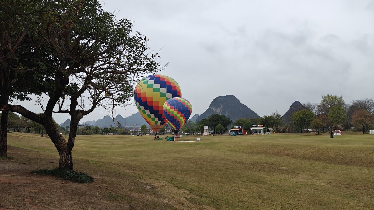 Balloons with mountains and cafe