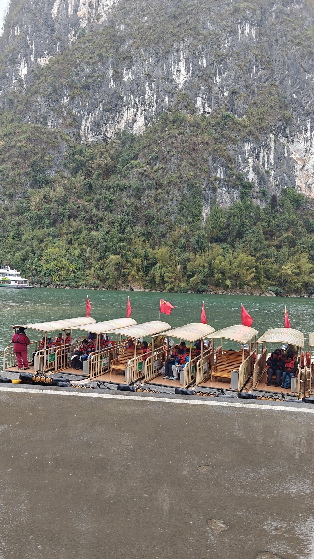 Bamboo rafts docked with red flags