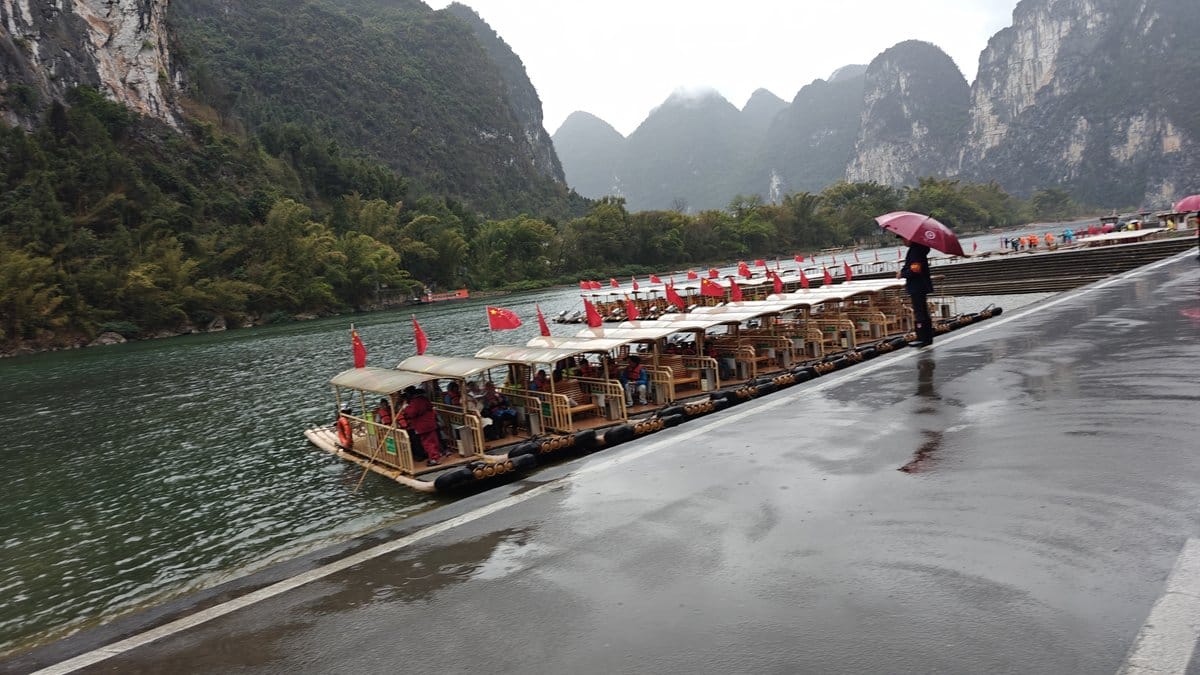 Bamboo rafts waiting in rainy mist