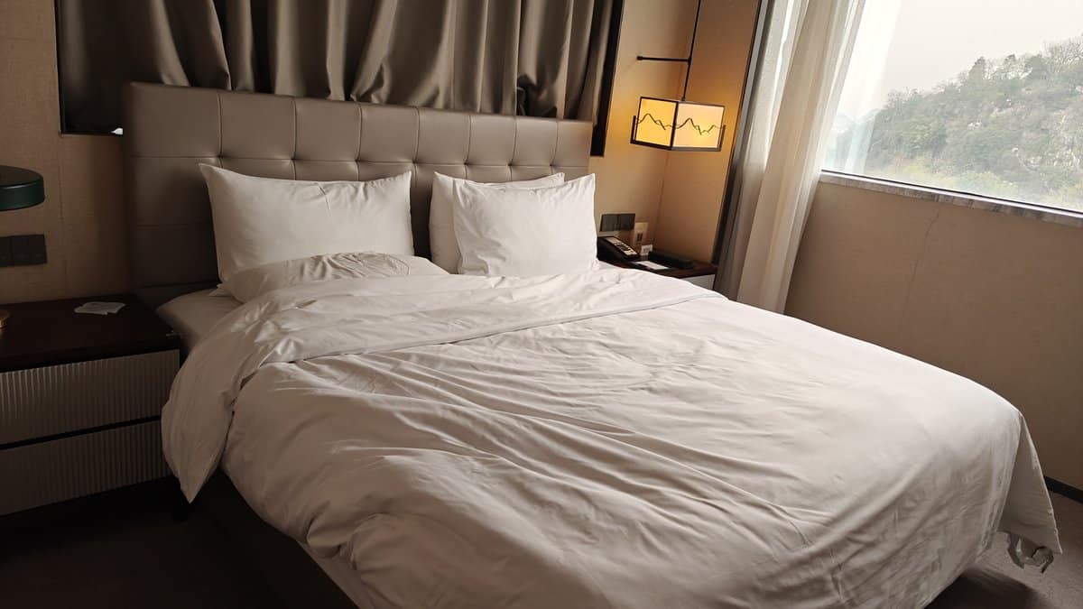 Bed white linens mountain view