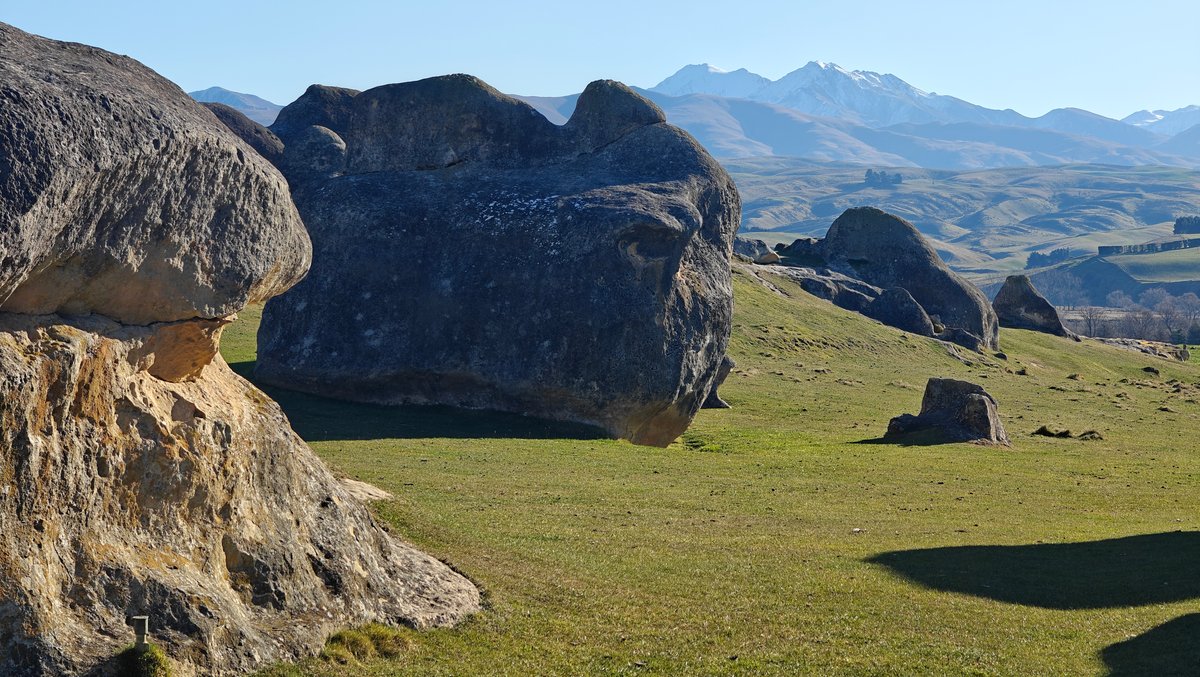 Boulders under snow-capped range