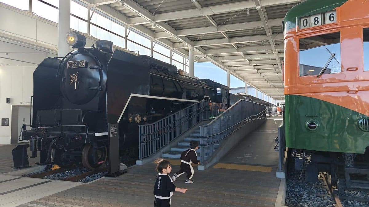 Children near vintage trains indoors
