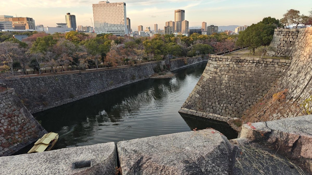 City skyline over ancient stone moat