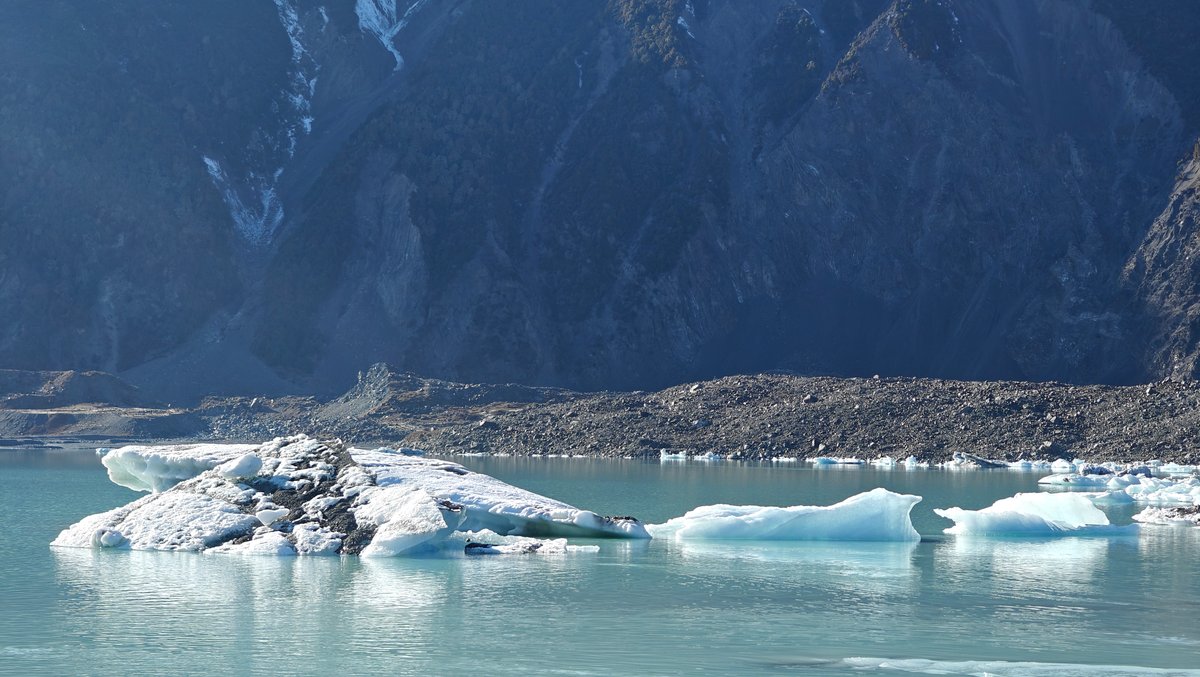 Close-up blue-tinged iceberg reflection