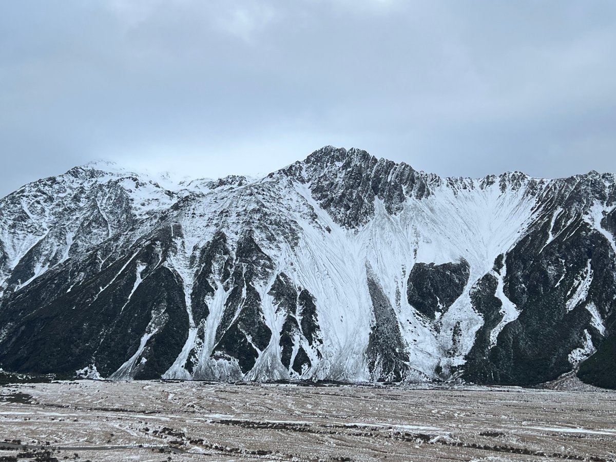 Close view of the snow-streaked scree slopes and