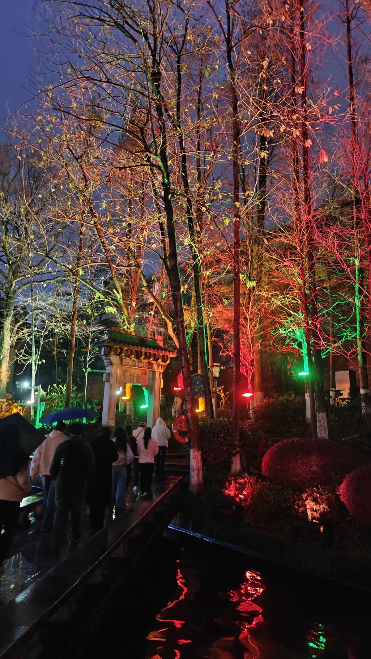 Colorful lit walkway with Chinese gate
