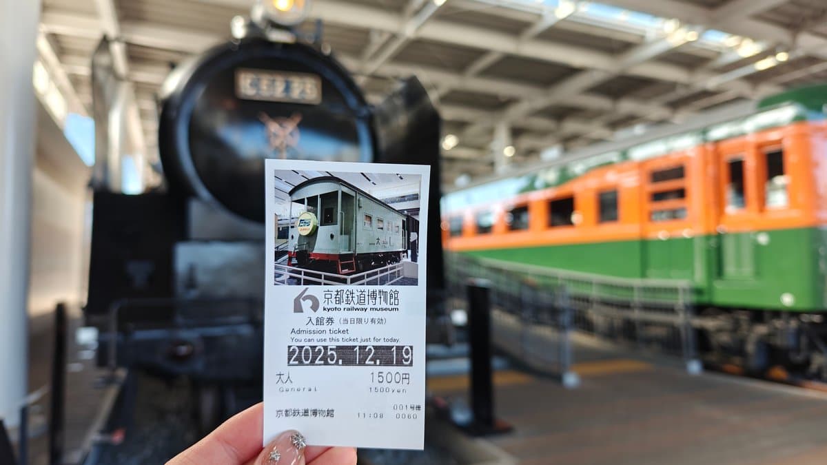 Commemorative ticket held up in front of the