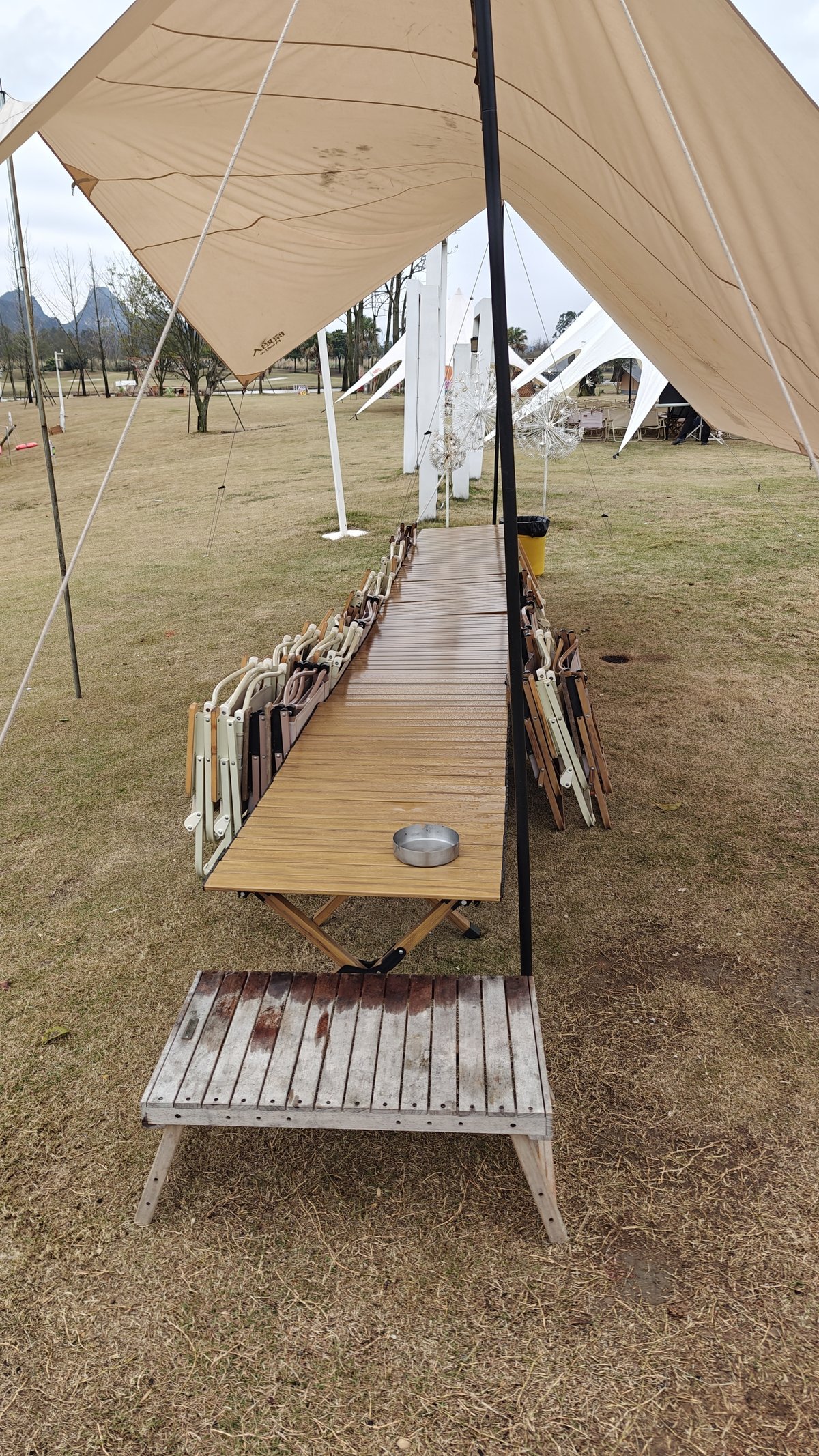 Communal dining table under tent