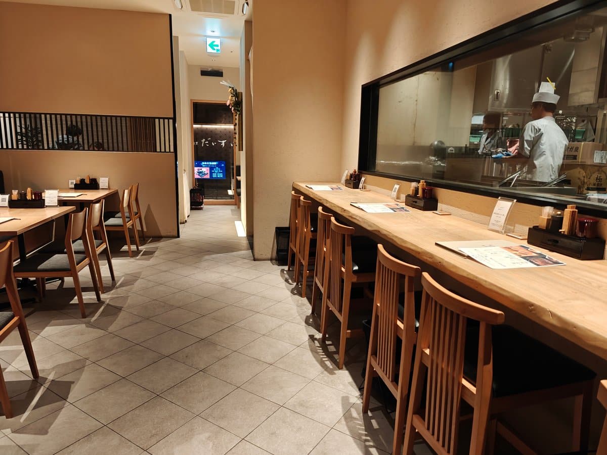 Counter seating facing the open kitchen where a
