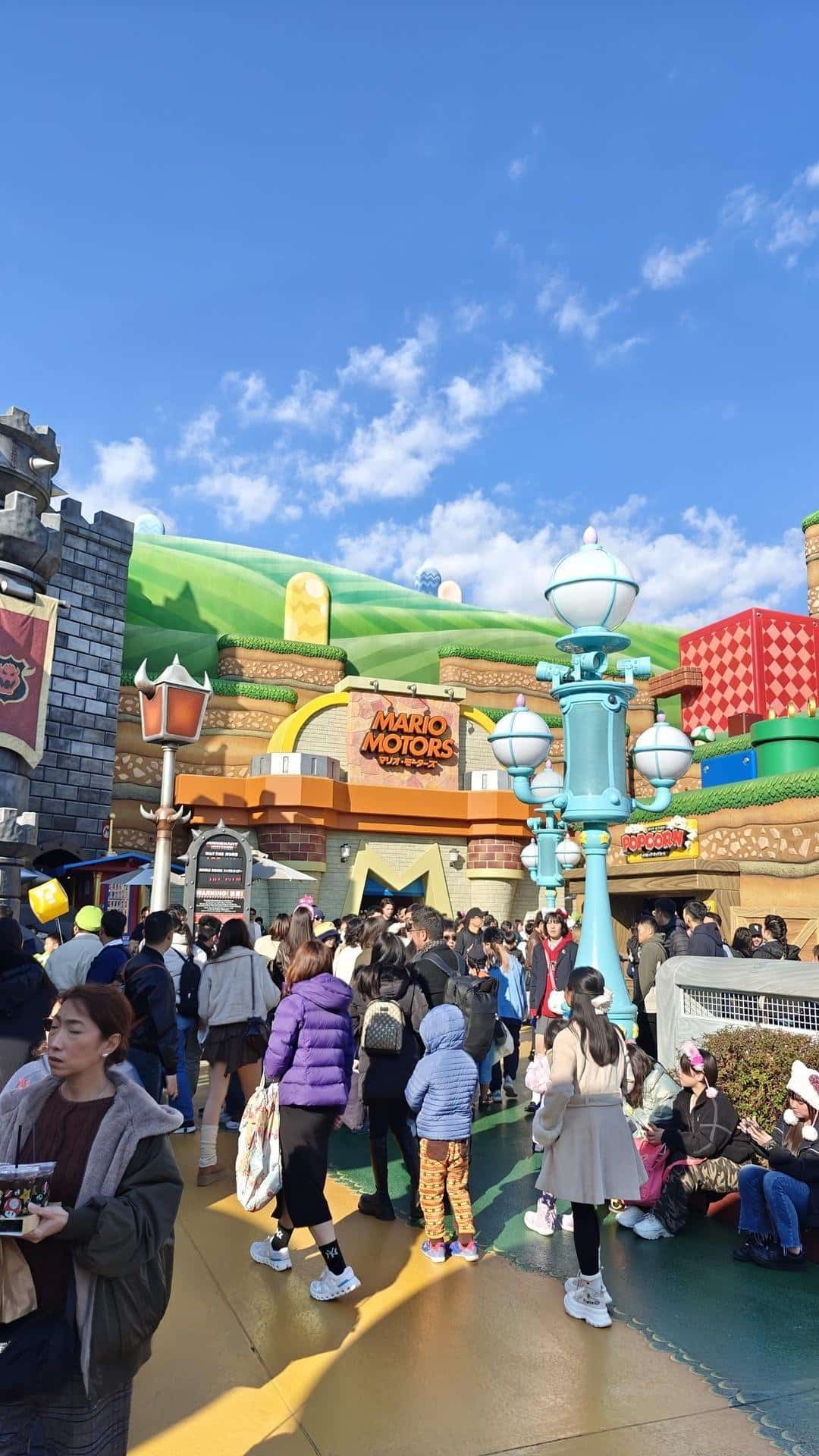 Crowd at colorful amusement park area