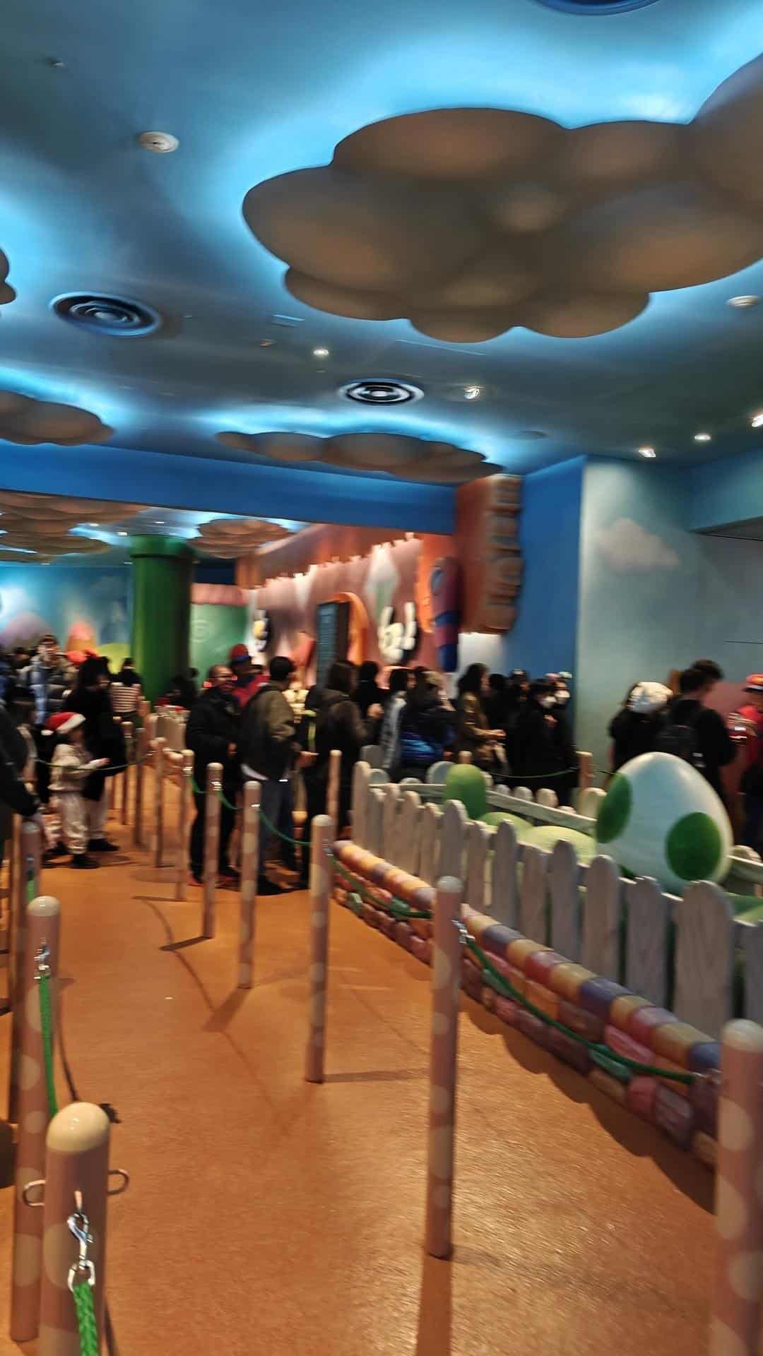 Crowd in themed colorful queue area