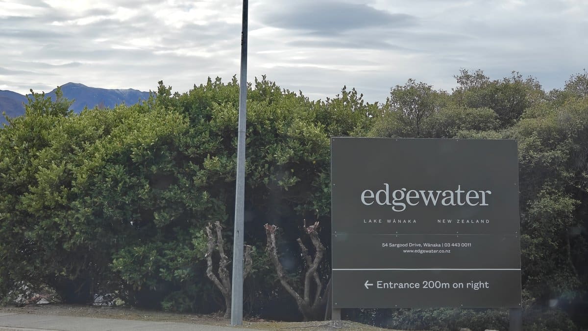 Dark entrance sign reading 'edgewater - LAKE WANAKA',