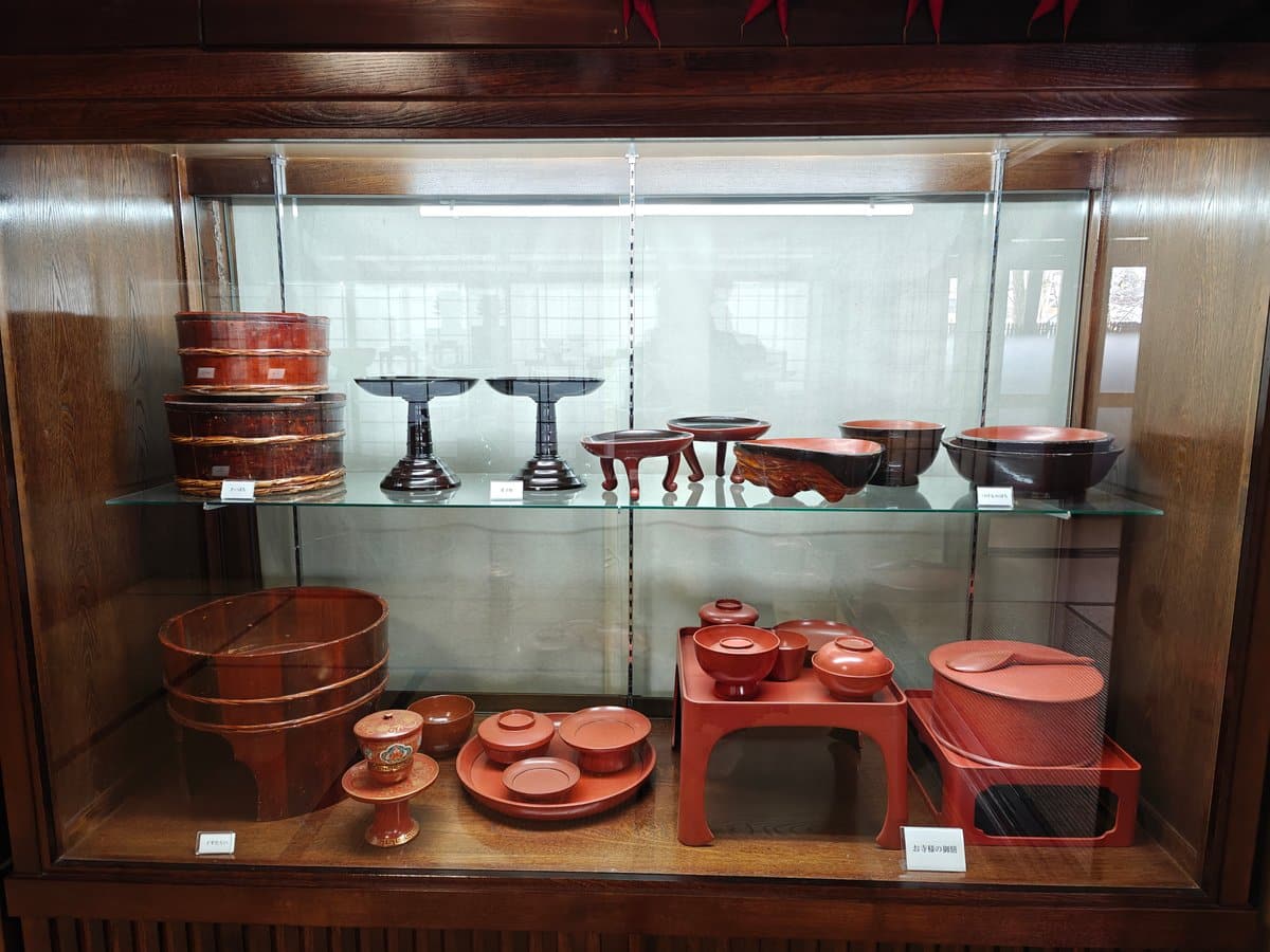 Display case of red lacquerware: footed offering stands